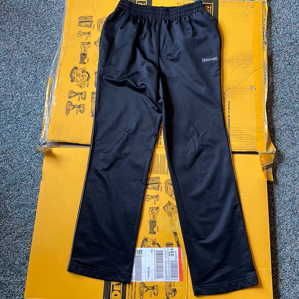 Black Spalding brand men’s jogger pants with thin gray stripe down the side